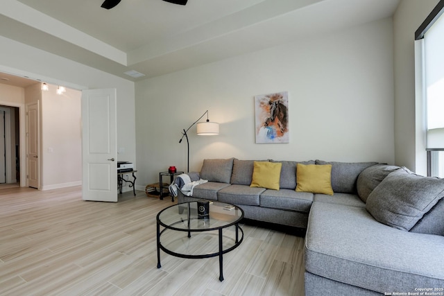 living room with ceiling fan and light wood-type flooring