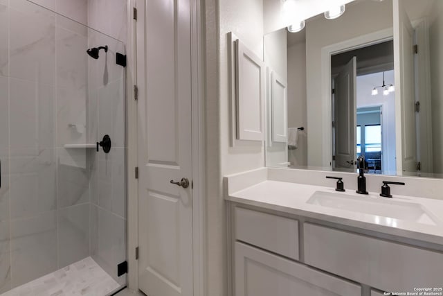 bathroom with vanity and a shower with shower door