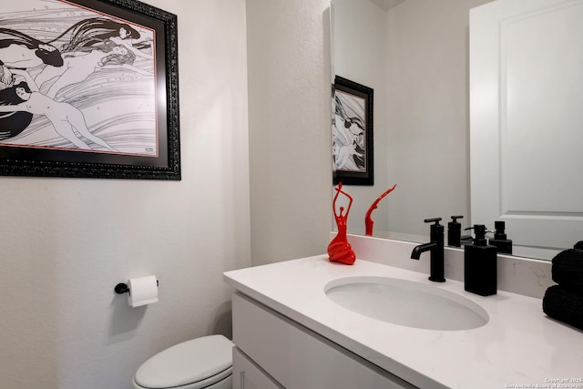 bathroom with vanity and toilet