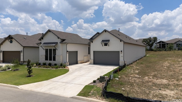 view of front of home with a garage and a front lawn