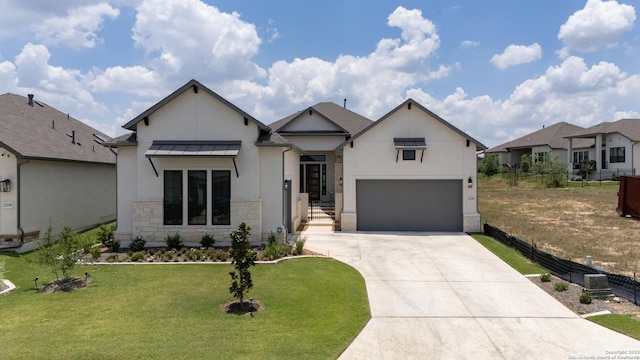 view of front of property with a garage and a front lawn