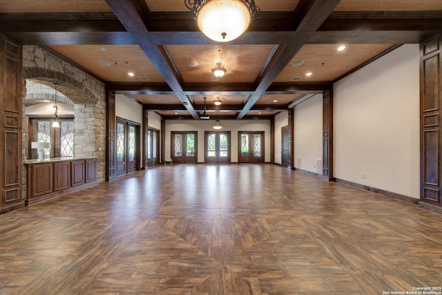 unfurnished room featuring coffered ceiling, parquet floors, and beamed ceiling