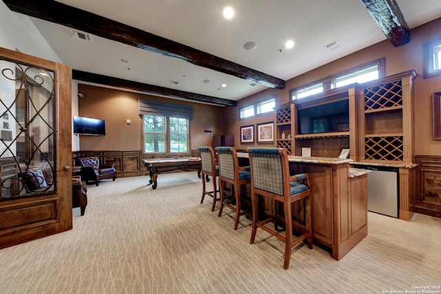 bar featuring beamed ceiling, dishwasher, and light carpet