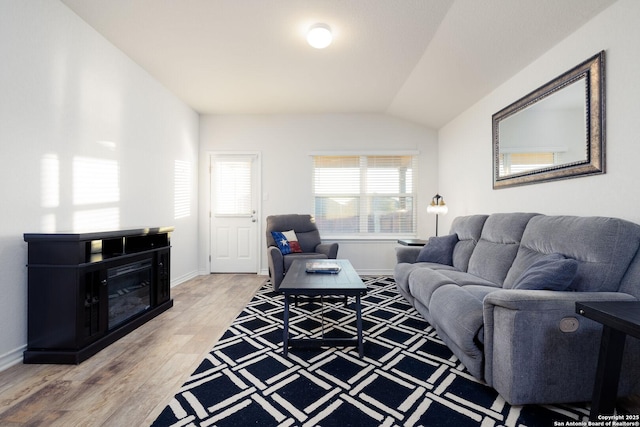 living room with lofted ceiling and hardwood / wood-style floors