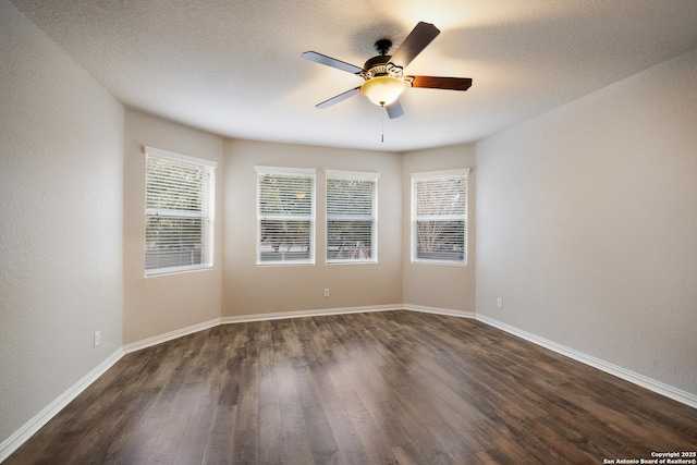 unfurnished room featuring ceiling fan and dark hardwood / wood-style flooring