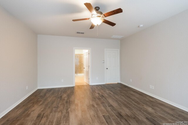 empty room with dark hardwood / wood-style floors and ceiling fan