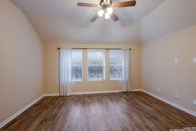 empty room featuring ceiling fan, lofted ceiling, and dark hardwood / wood-style floors