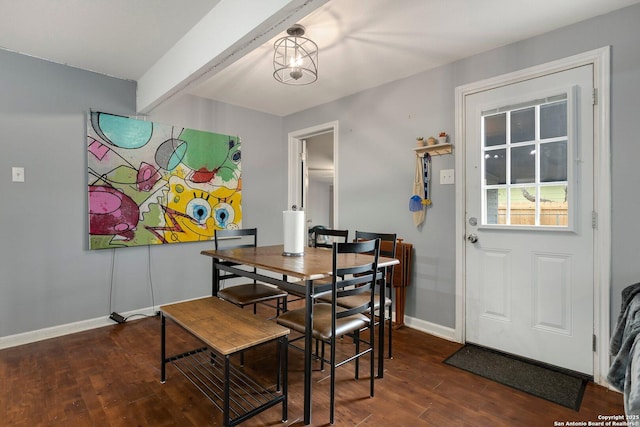 dining area with dark wood-type flooring and beamed ceiling