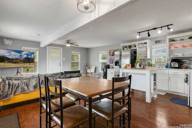 dining space featuring dark wood-type flooring, ceiling fan, and beam ceiling