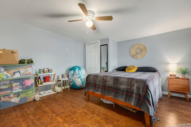 bedroom with hardwood / wood-style flooring, ceiling fan, and a closet