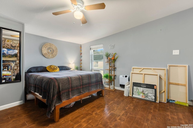 bedroom with dark hardwood / wood-style floors and ceiling fan