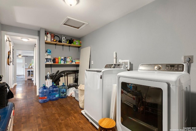 laundry area featuring dark wood-type flooring and washer and clothes dryer