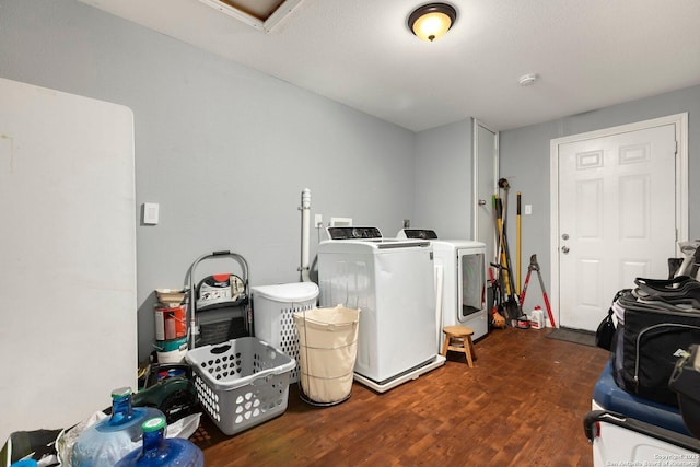 clothes washing area with independent washer and dryer and dark hardwood / wood-style flooring