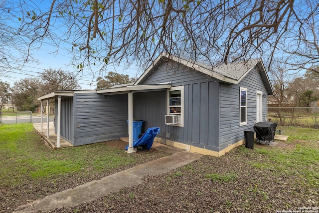 view of side of property featuring a yard and cooling unit