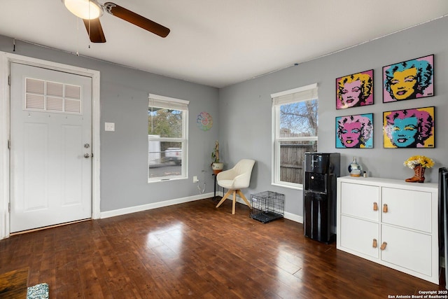 sitting room with dark hardwood / wood-style floors, a wealth of natural light, and ceiling fan