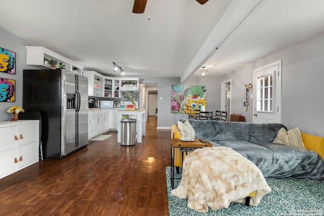 living room featuring ceiling fan and dark hardwood / wood-style flooring