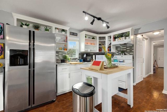 kitchen with butcher block countertops, white appliances, dark wood-type flooring, white cabinetry, and a center island