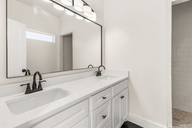 bathroom with vanity and a tile shower