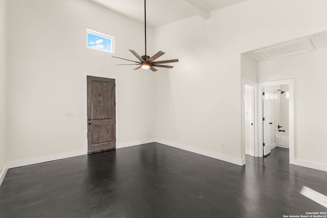 interior space with beam ceiling, a towering ceiling, and ceiling fan