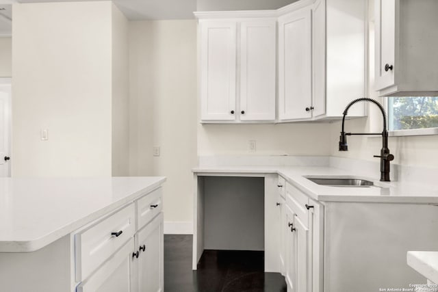 kitchen featuring sink, dark wood-type flooring, and white cabinets