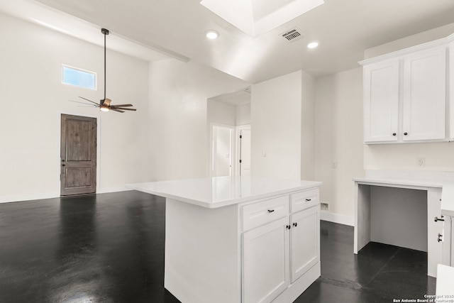 kitchen featuring white cabinetry, ceiling fan, hanging light fixtures, and a kitchen island