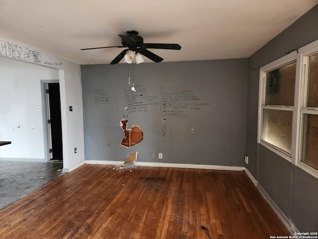 spare room featuring dark hardwood / wood-style floors and ceiling fan