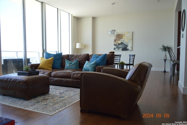 living room with floor to ceiling windows and dark hardwood / wood-style floors