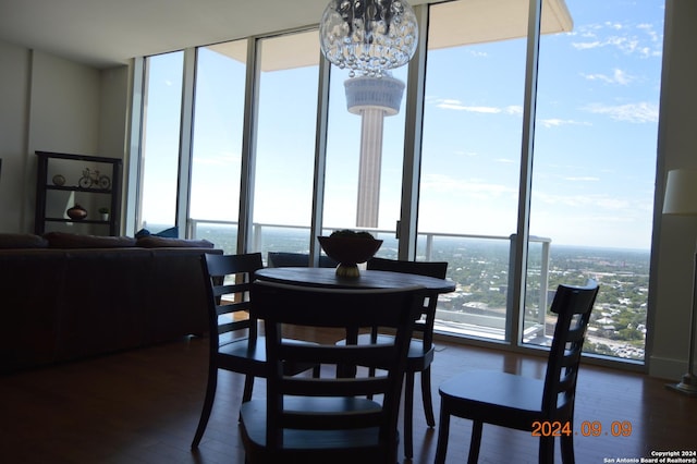 dining room with a notable chandelier, dark hardwood / wood-style floors, and floor to ceiling windows