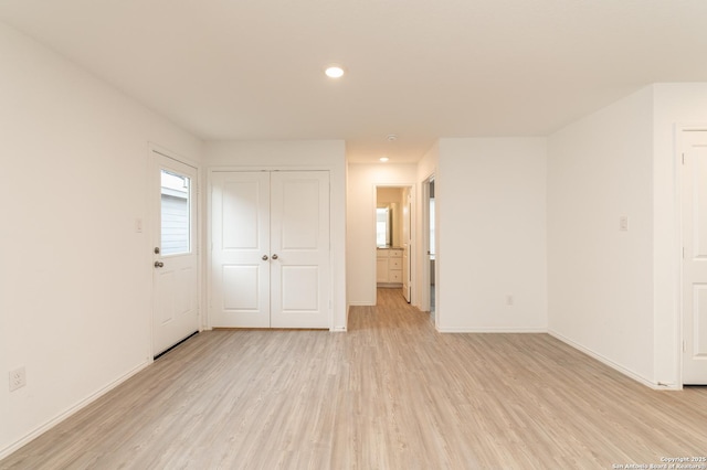 unfurnished bedroom featuring light hardwood / wood-style floors and a closet