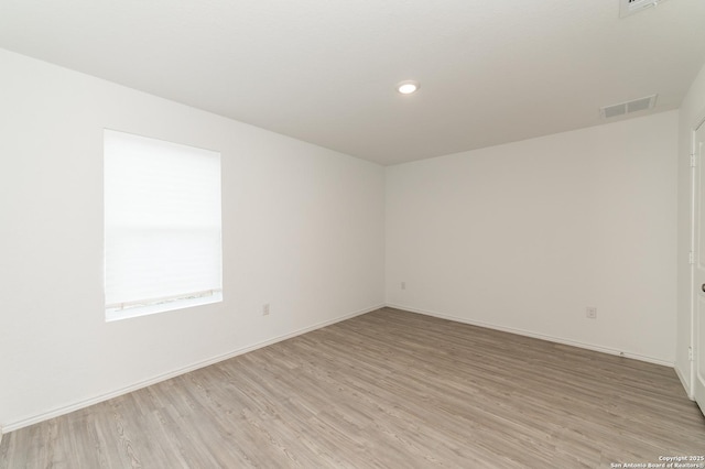 spare room featuring light wood-type flooring