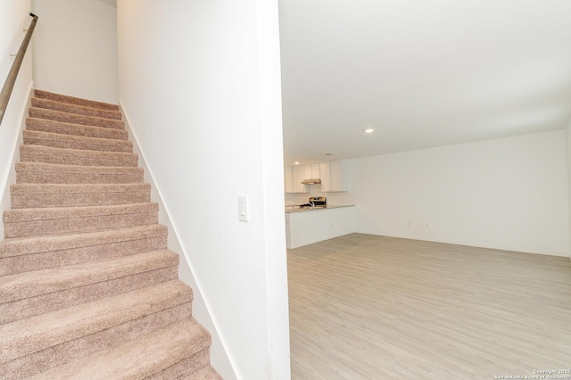 staircase featuring hardwood / wood-style flooring