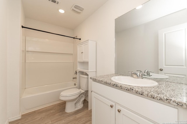 full bathroom with toilet, wood-type flooring, shower / washtub combination, and vanity