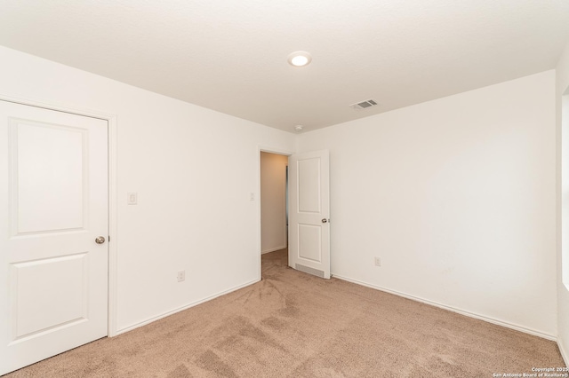 empty room with light colored carpet