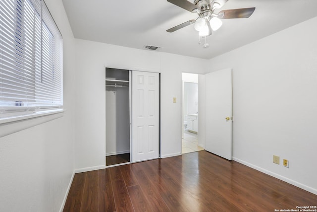 unfurnished bedroom featuring hardwood / wood-style floors, ceiling fan, and a closet