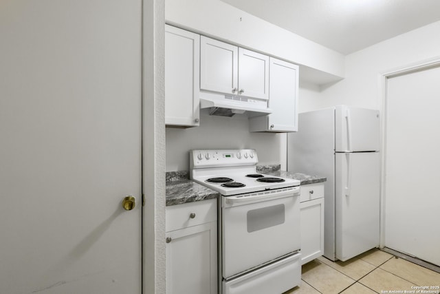 kitchen with white cabinetry, light tile patterned floors, white appliances, and dark stone counters