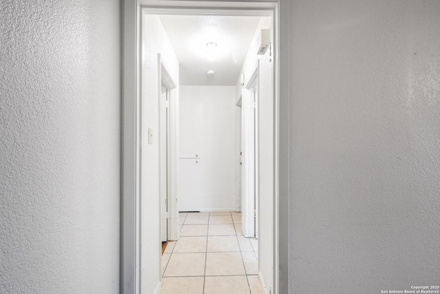 hall featuring light tile patterned floors