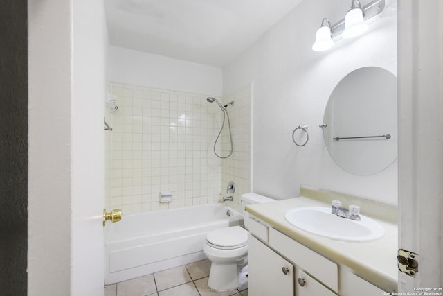 full bathroom featuring tile patterned floors, toilet, tiled shower / bath combo, and vanity