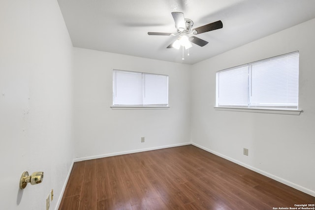 unfurnished room featuring dark wood-type flooring and ceiling fan