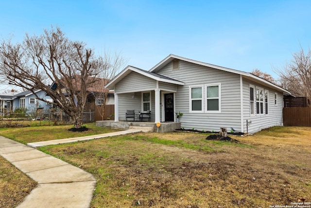 view of front facade with covered porch and a front lawn