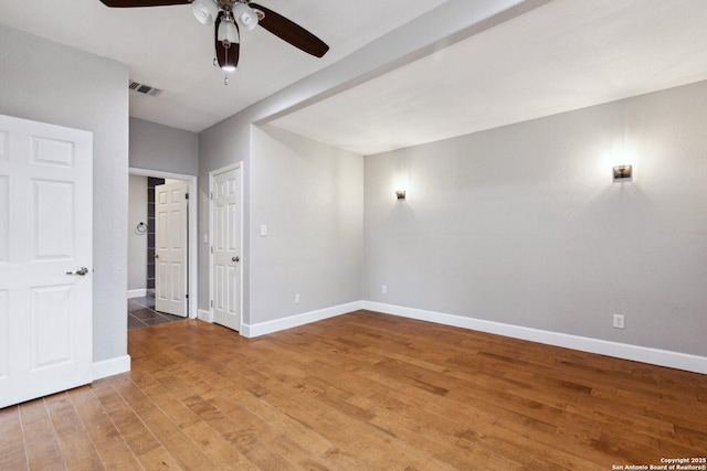 spare room with hardwood / wood-style floors and ceiling fan