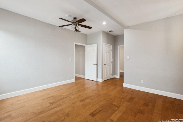 empty room with hardwood / wood-style flooring and ceiling fan