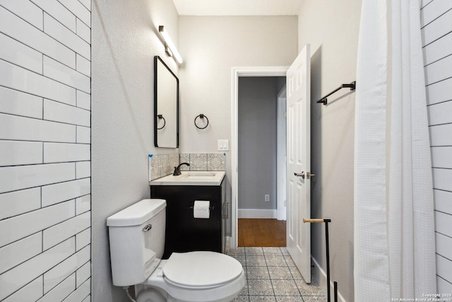 bathroom with vanity, tile patterned flooring, and toilet