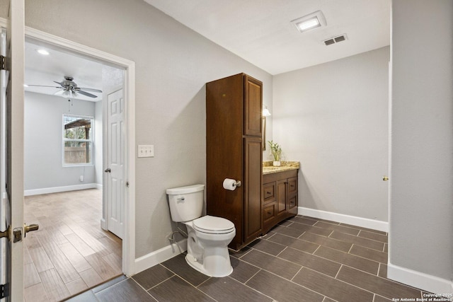 bathroom featuring ceiling fan, vanity, and toilet