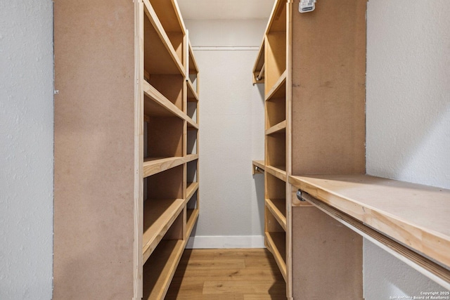 spacious closet featuring light hardwood / wood-style floors