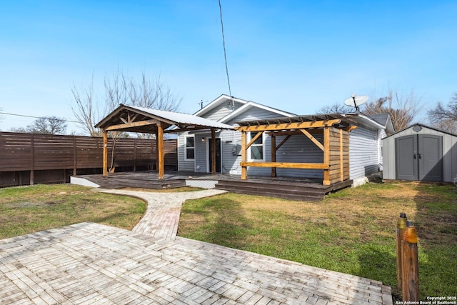 view of front of home featuring a storage shed, a patio area, a gazebo, a pergola, and a wooden deck