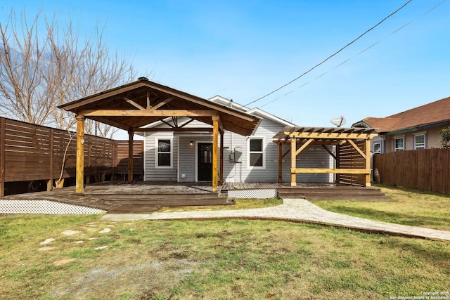 view of front of house with a wooden deck, a pergola, and a front yard