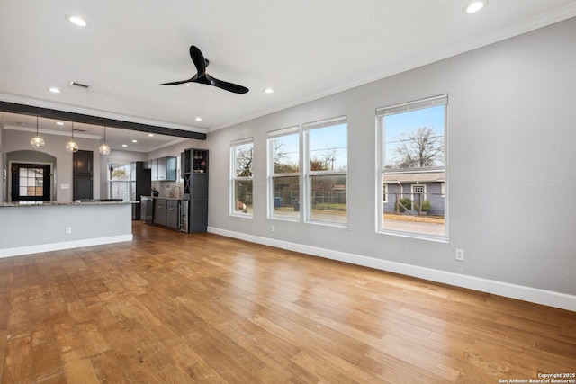 unfurnished living room with plenty of natural light and light hardwood / wood-style floors