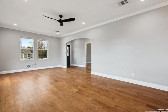 unfurnished room featuring ceiling fan, wood-type flooring, and ornamental molding