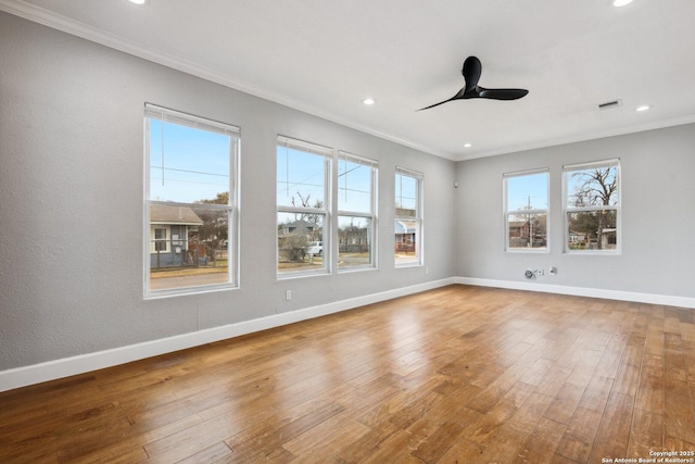 spare room with wood-type flooring, ceiling fan, and crown molding