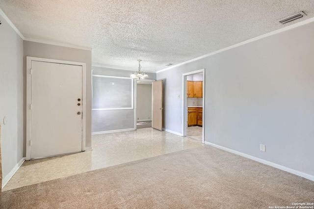 unfurnished room with a textured ceiling and a notable chandelier